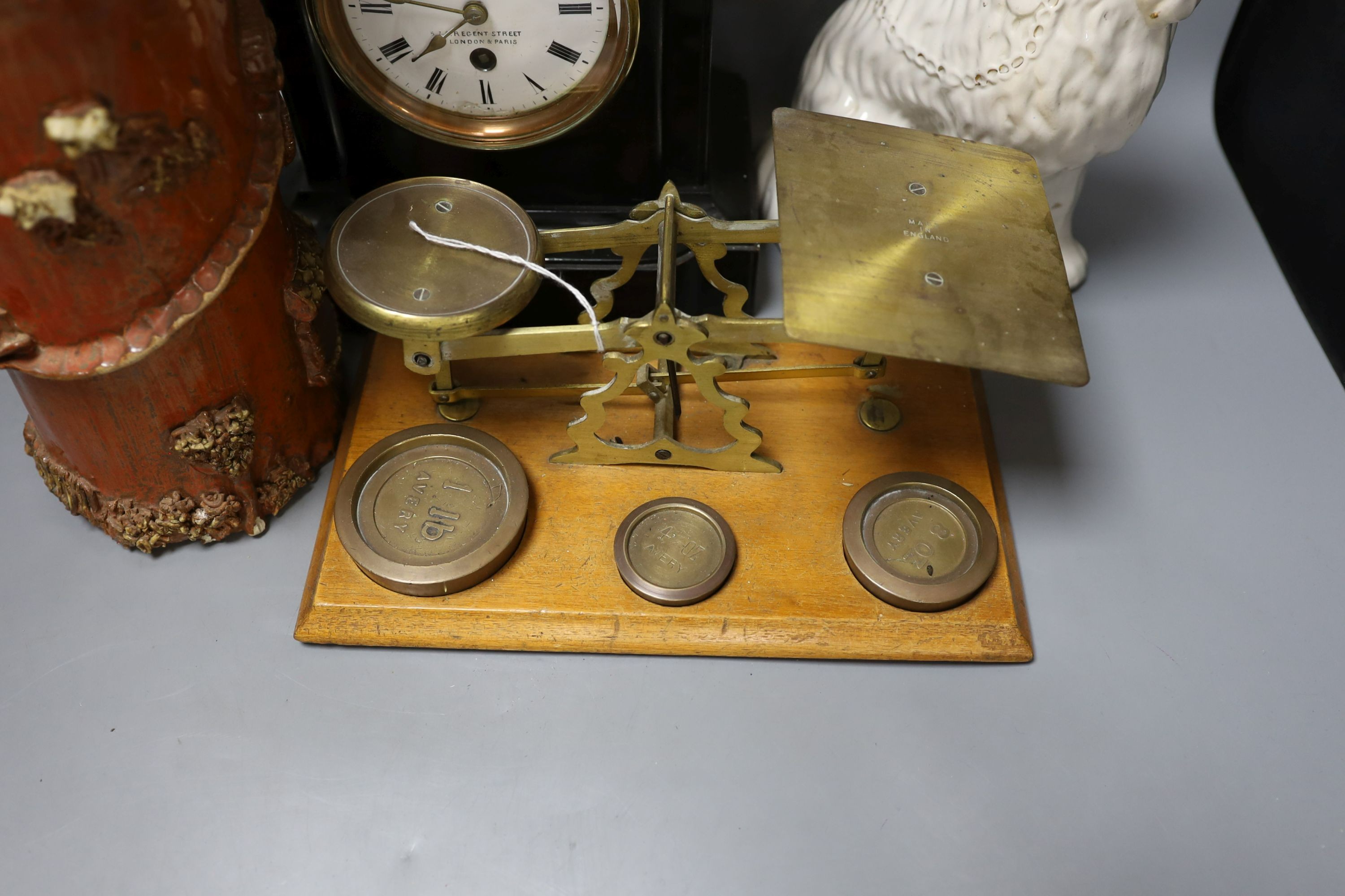 A pair of Staffordshire dogs, together with a pottery brush pot, Howell James mantle clock and other miscellaneous items including postal scales (7)